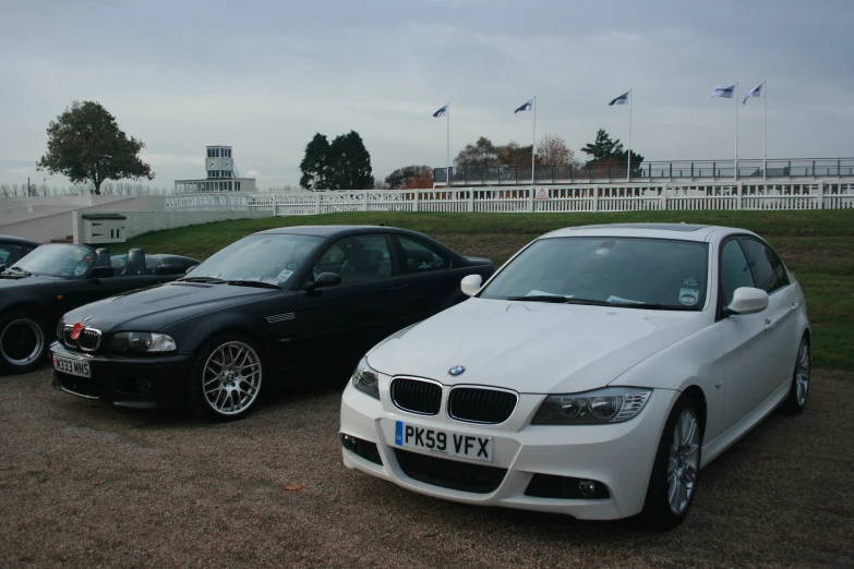 three black and white cars are in the parking lot