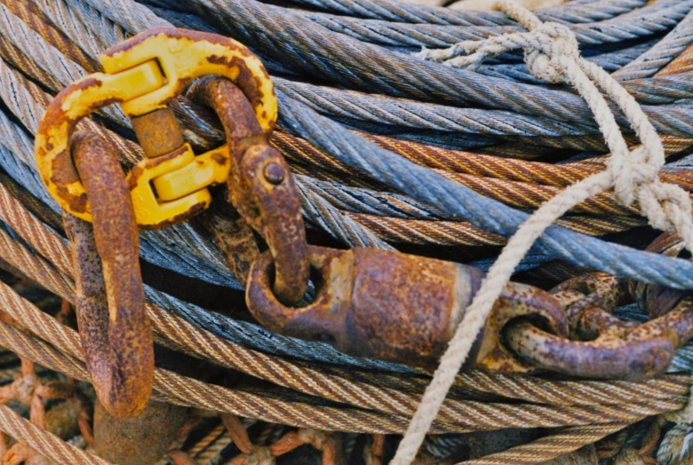a set of rusty chain and two safety chains attached to ropes
