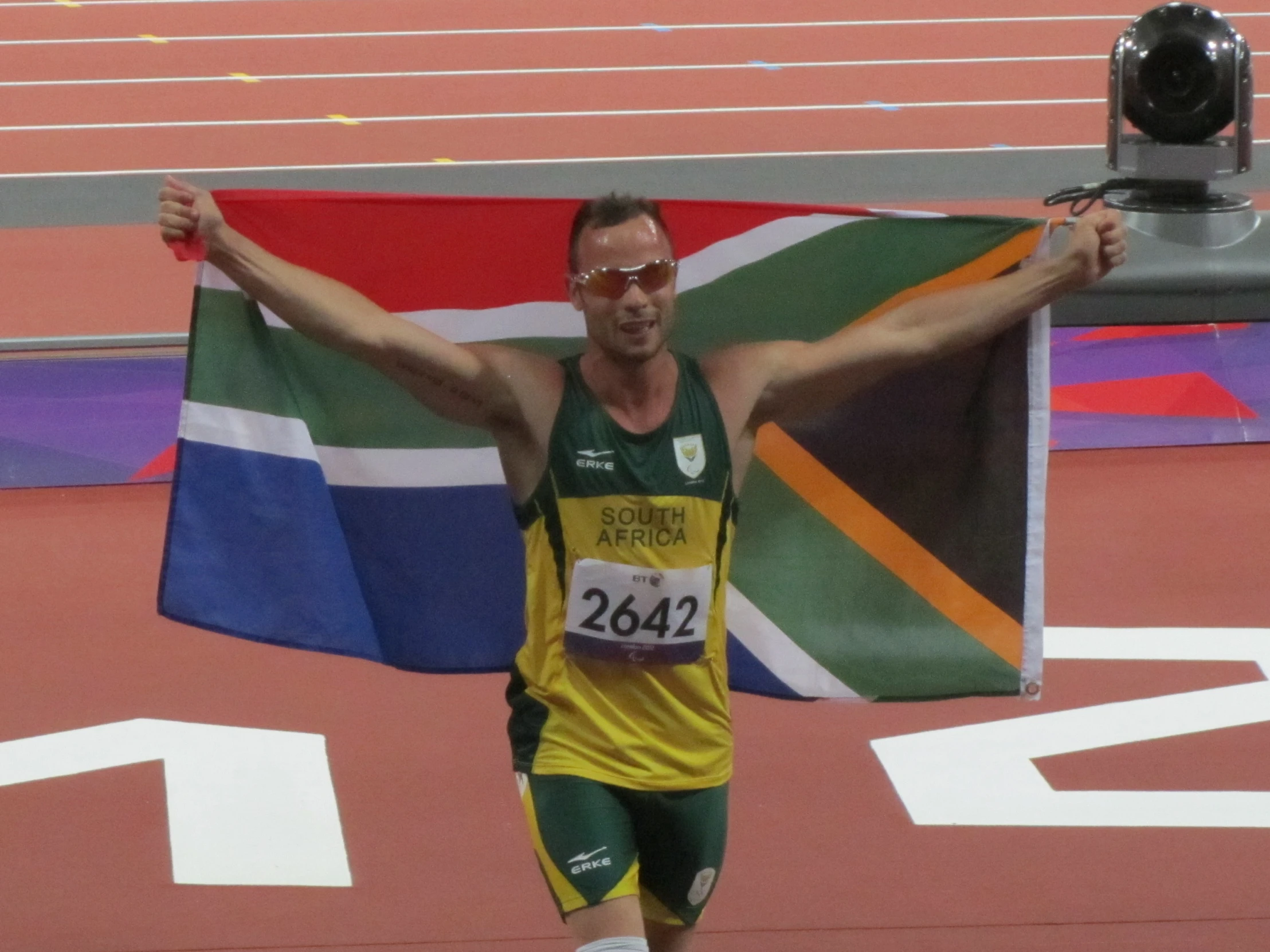 a man on the track holding up a flag