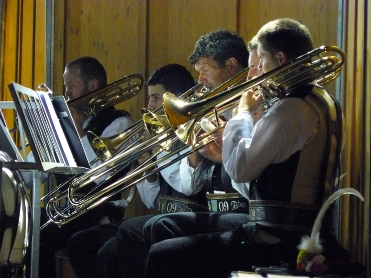 some musicians sitting in chairs holding musical instruments