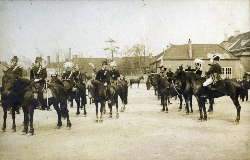 the men are riding horses and wearing many hats