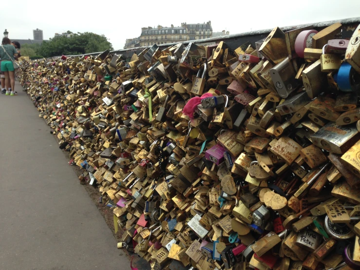 a large wooden gate has many padlocks on it