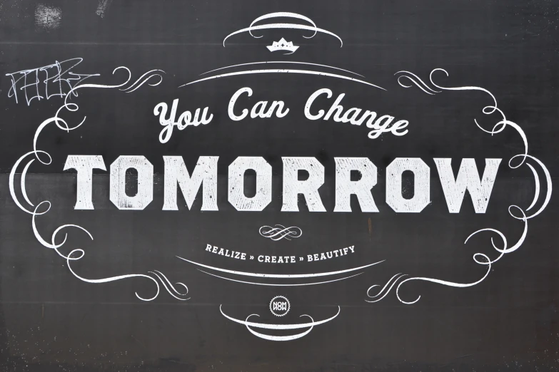 the word you can change tomorrow written on a blackboard