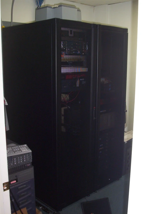 a black storage cabinet with an electronic amplifier