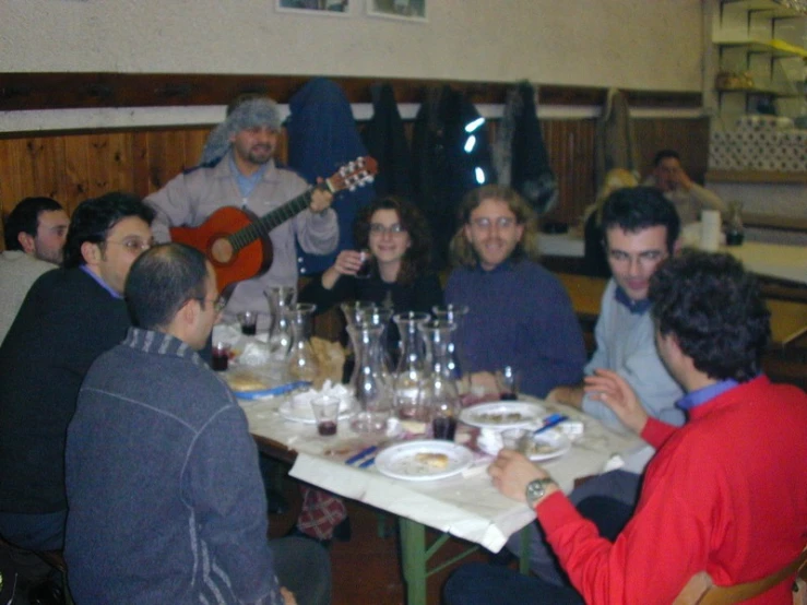 group of people sitting at a table with wine glasses