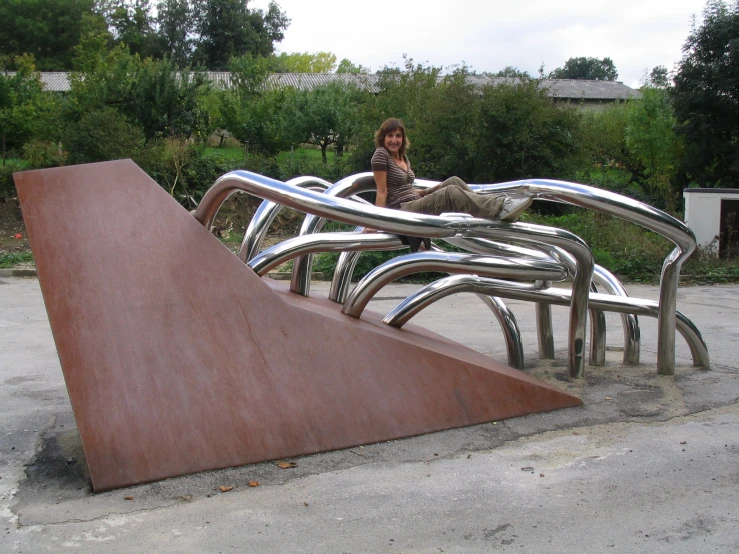 a metal sculpture sitting in the middle of a park