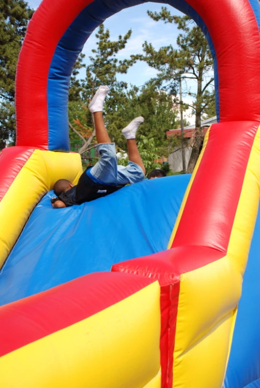 man jumping up on an obstacle inflatable