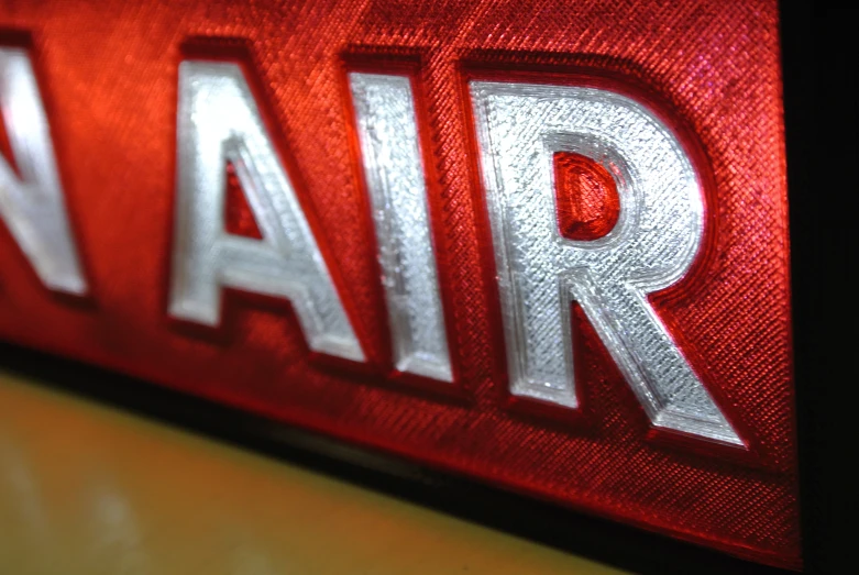 a red air sign that has white lettering on it