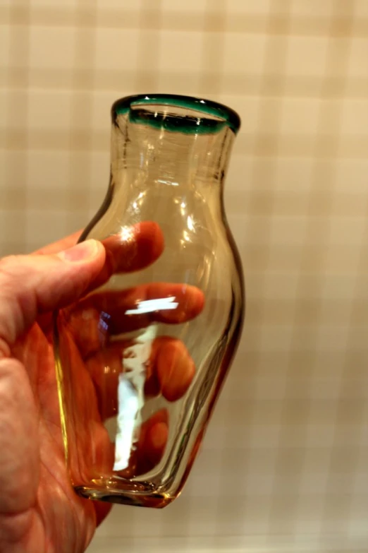 a close up of a person holding a glass