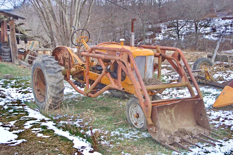 a tractor with two plows on the lawn