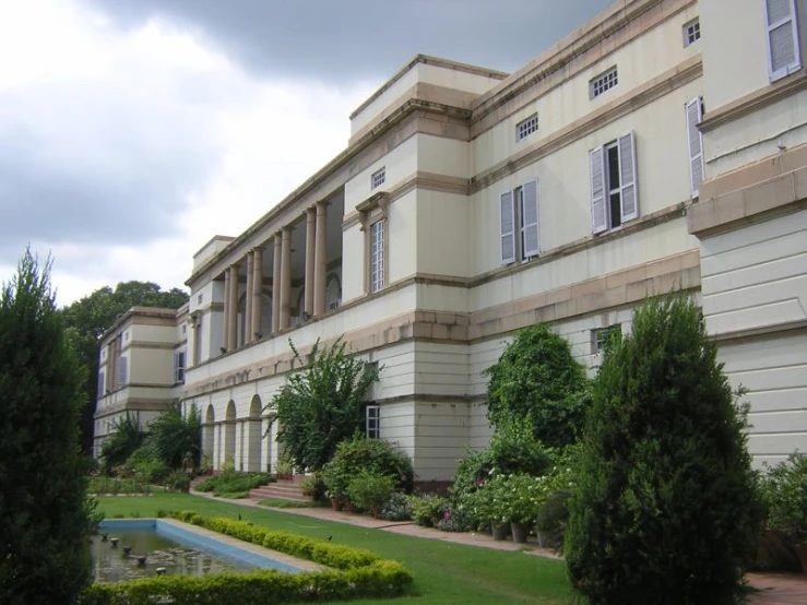 a beautiful mansion with trees and water fountain