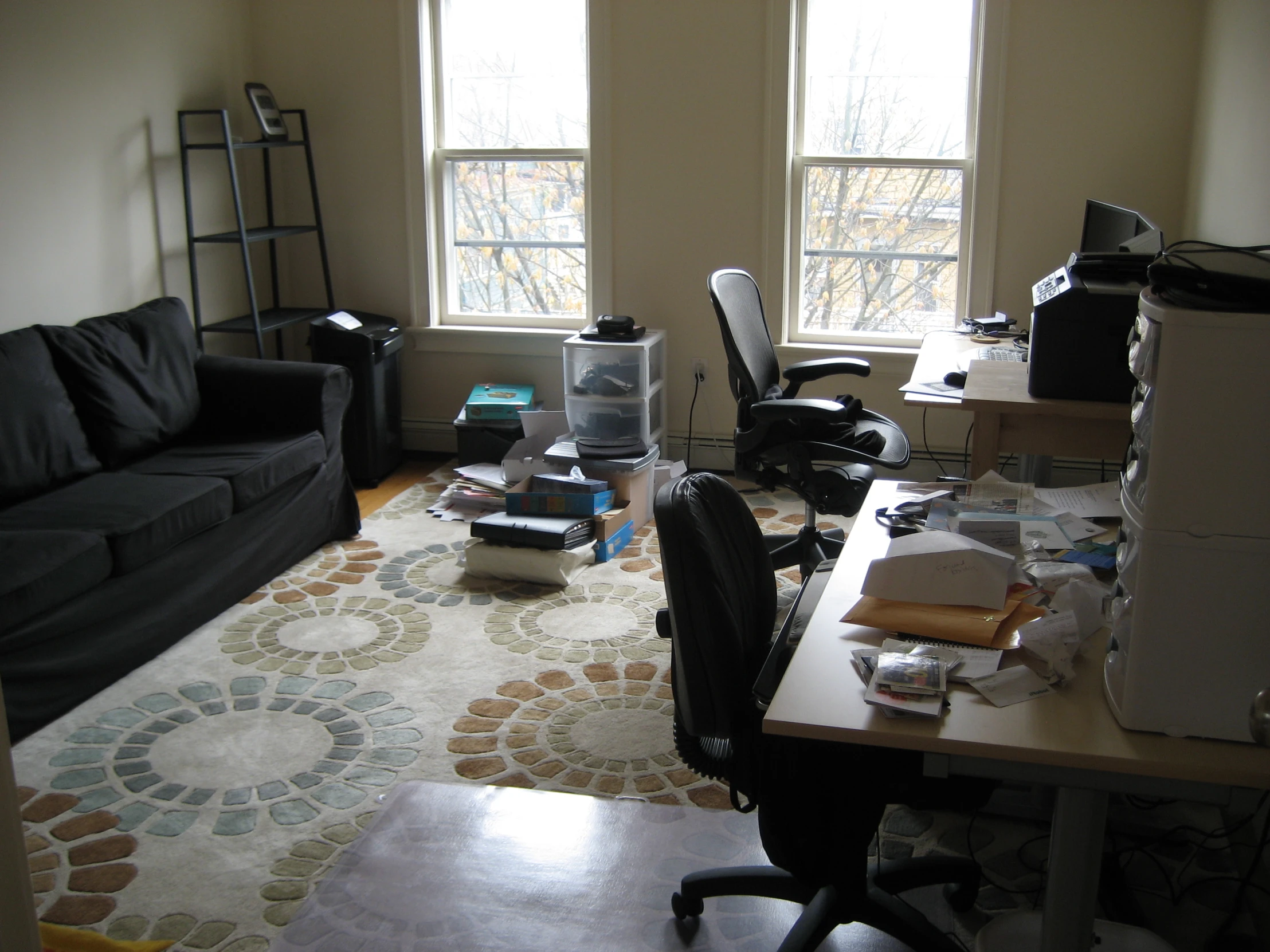 a living area with couch, computer, chair and desk in it