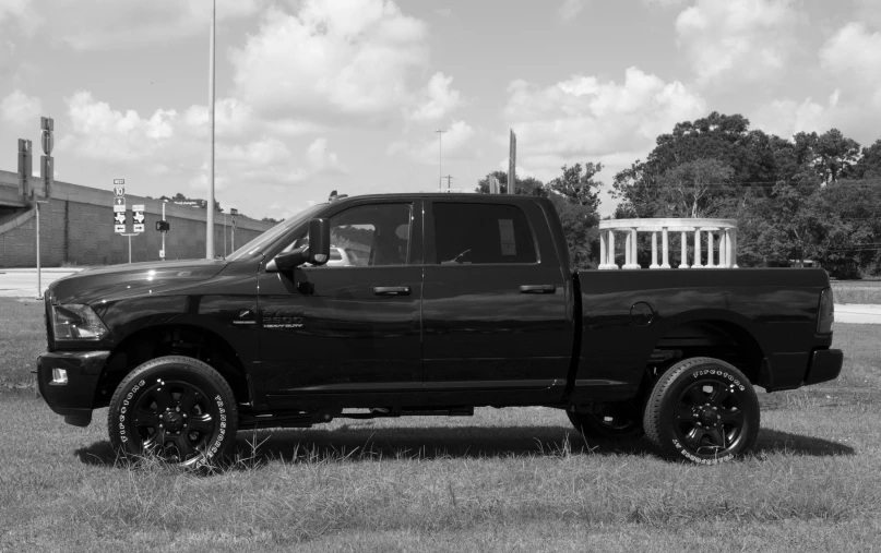 a black and white po of a pickup truck in the grass