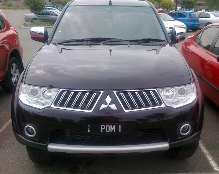 the front view of a black colored car parked in a lot