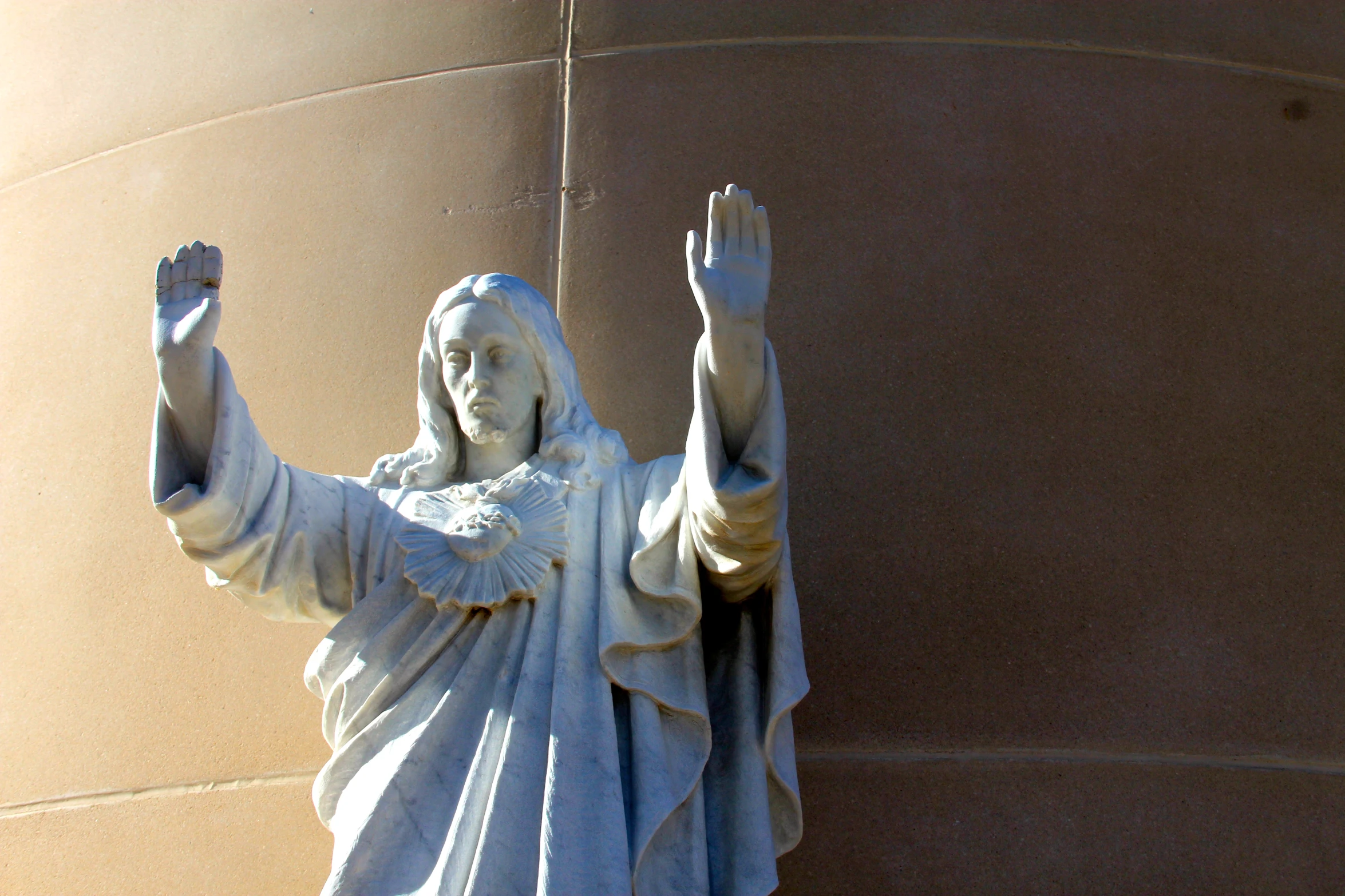 the statue of a woman is in front of a building