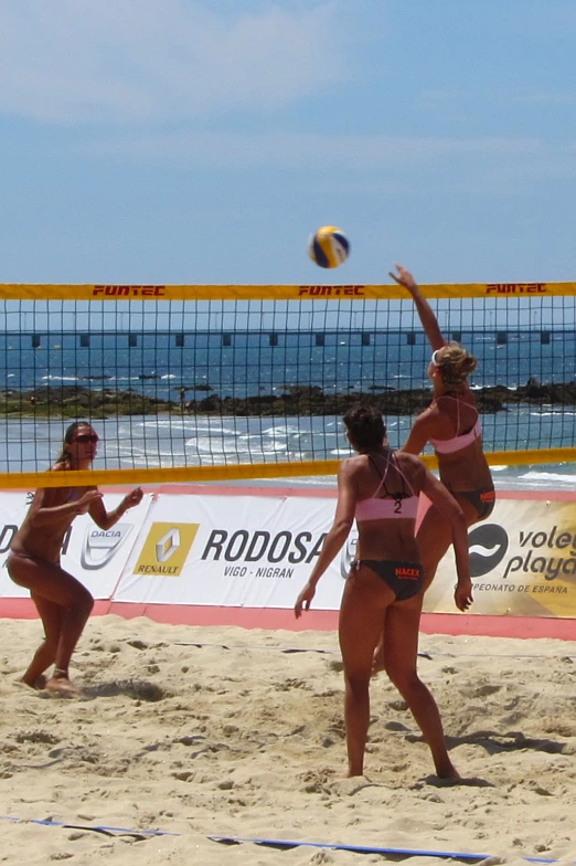 two women are playing volleyball with each other