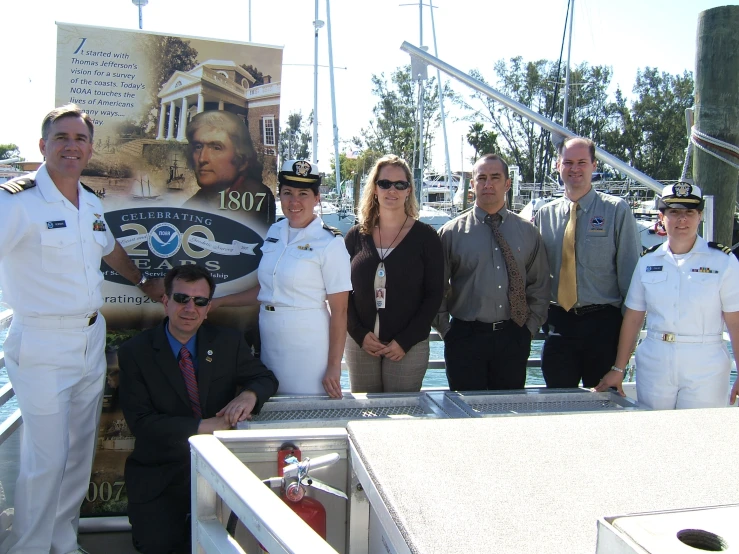 a group of people dressed in all white pose for a po