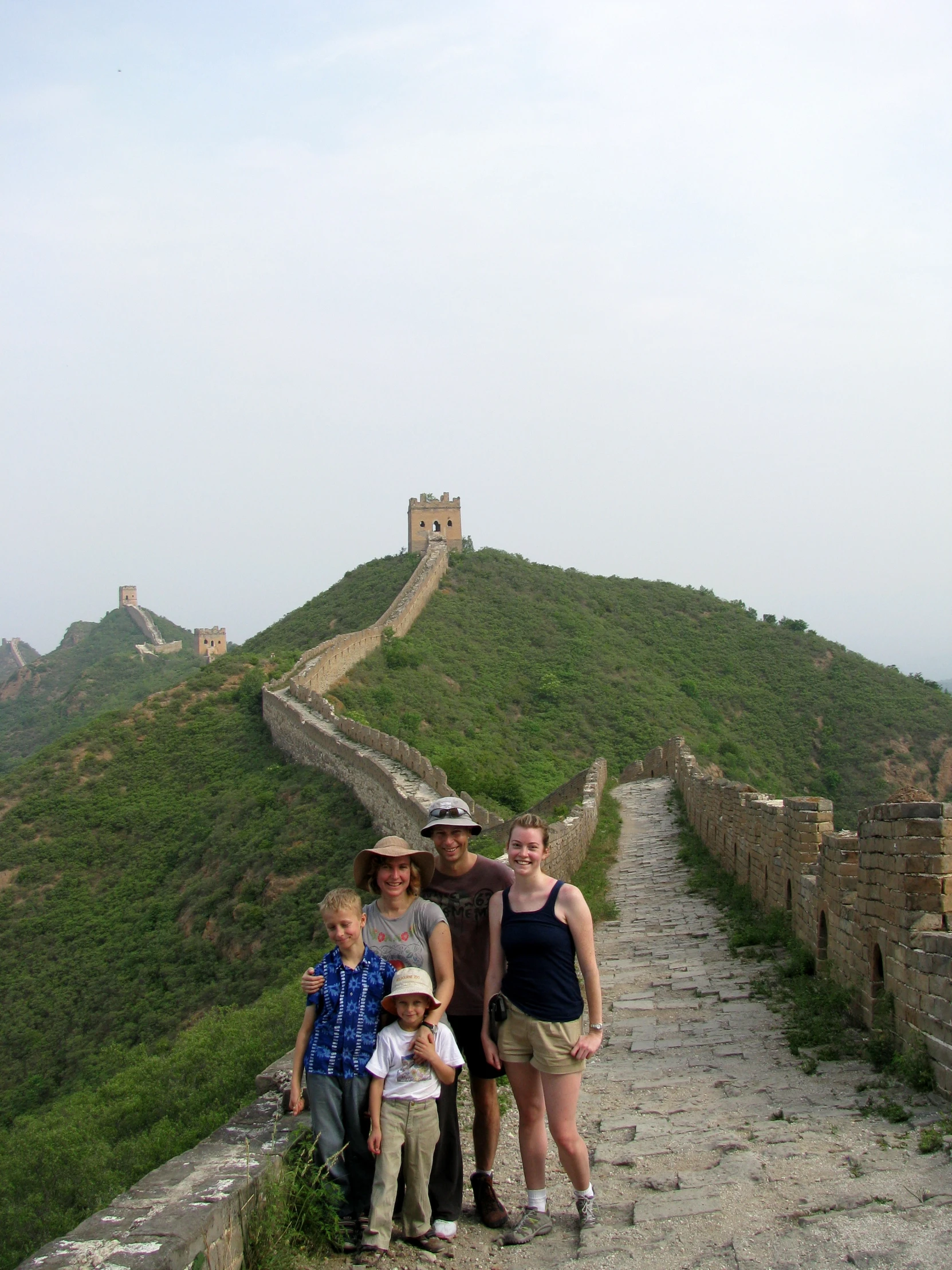 a family poses for a po on the great wall of china