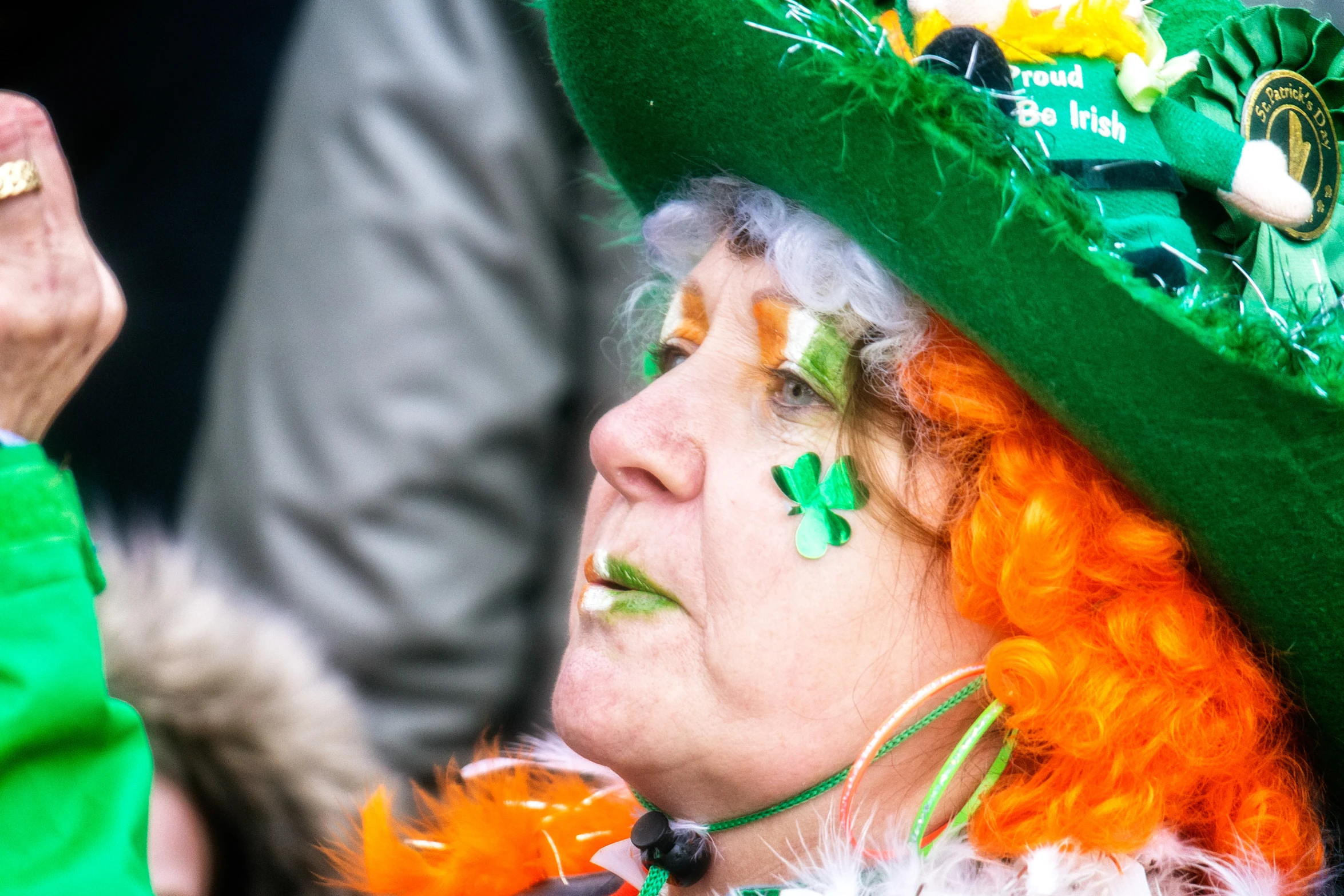 the woman is dressed in green and wearing a colorful hat