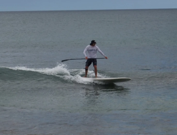 a man is riding on top of a surfboard