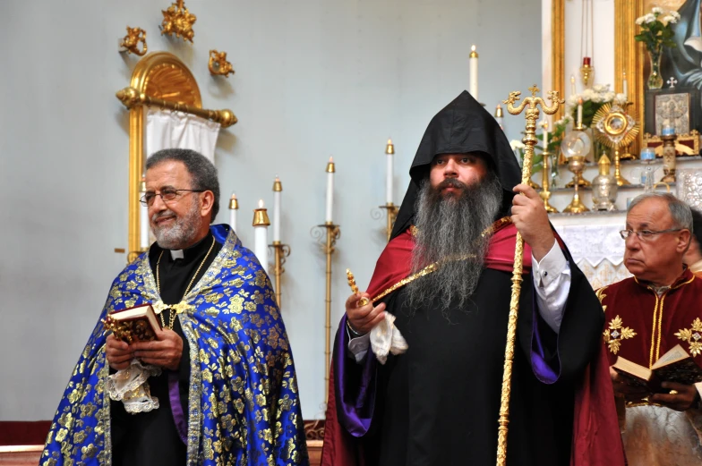 two men dressed up as priests and one wearing a robe