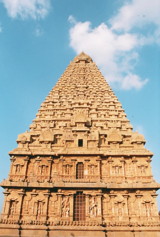 the large tower has several intricate carving around it