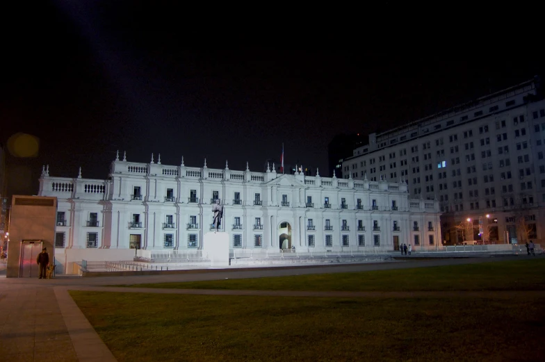 an image of building in a large field at night