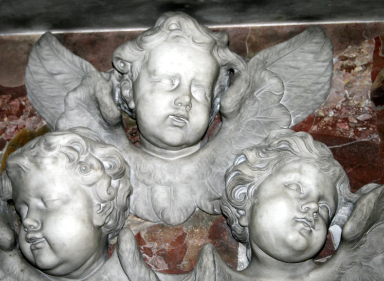 the three angels are sitting together by the marble