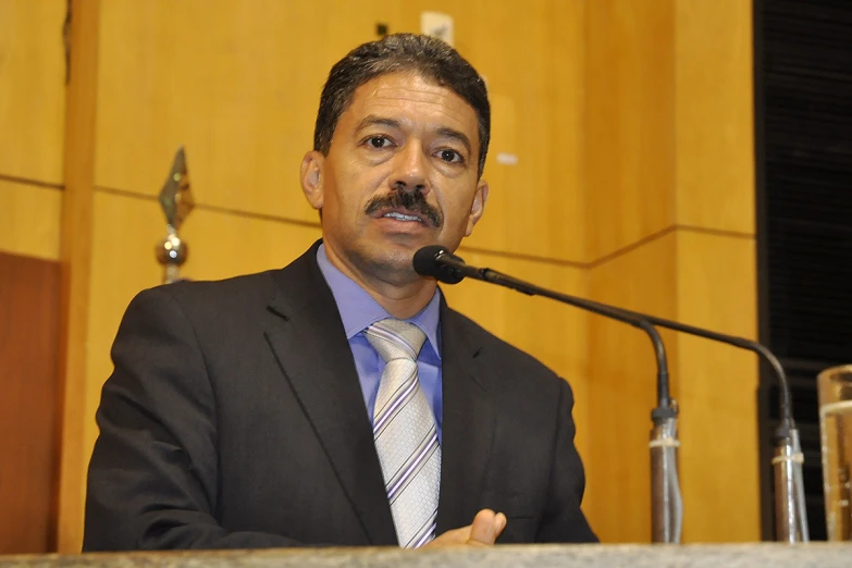 a man with a mustache wearing a suit and tie