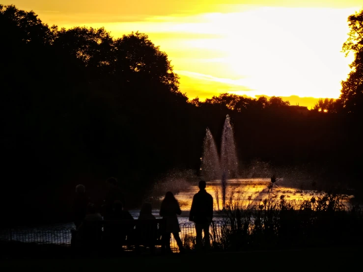 people are standing in front of a fountain