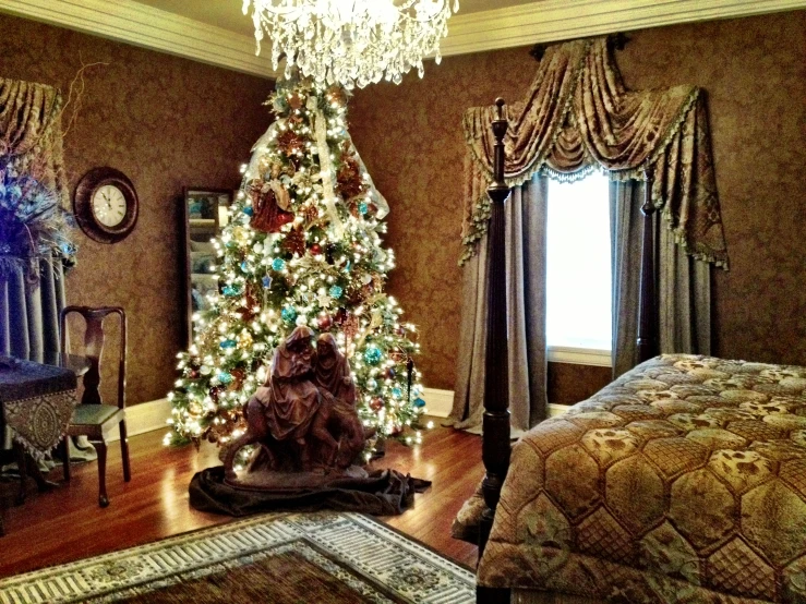 a white and gold christmas tree in a bedroom