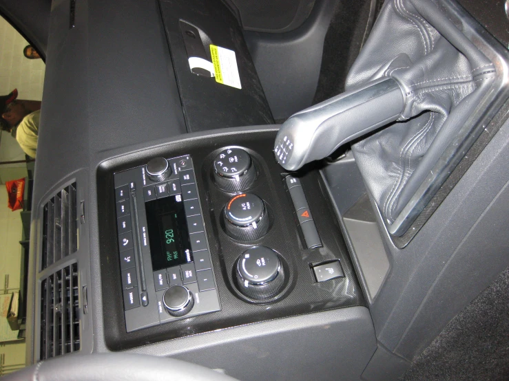 the inside dashboard of a modern vehicle shows radio controls and air vent