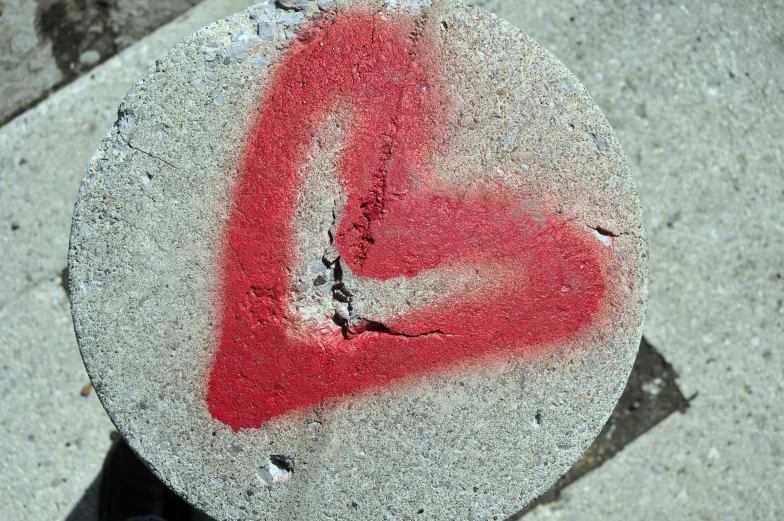 a close up of a piece of graffiti with red paint