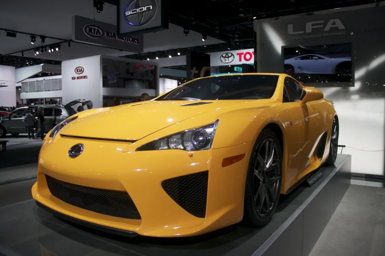 a sports car sits on display at a show