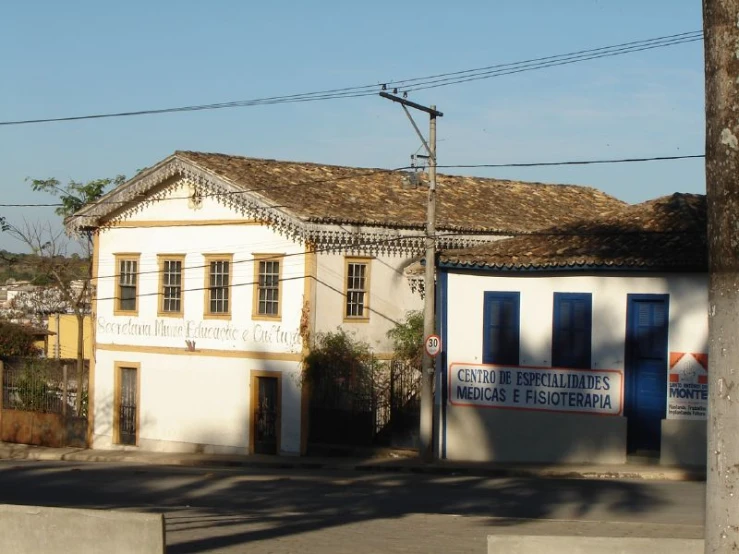 a white building with an arched window next to a street