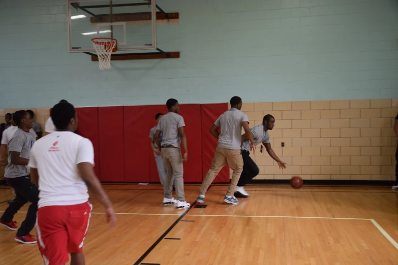 a basketball team practice in an indoor gymnasium