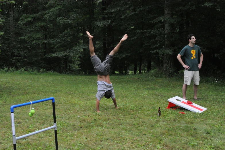 two people are playing frisbee in the grass