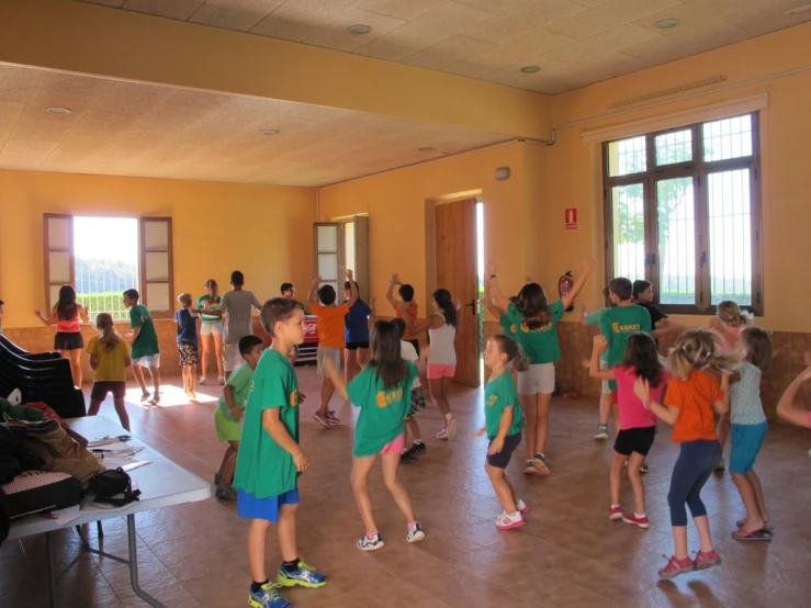 the children are playing in a large room