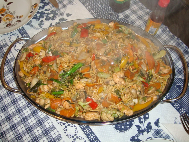 large, metal dish that contains mixed vegetables and chicken