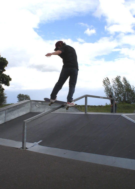 a man riding a skateboard down the side of a metal rail