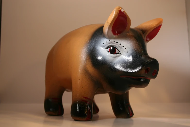 a ceramic sculpture of a cow standing in the center of a room