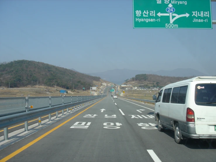 a van is driving past an exit sign