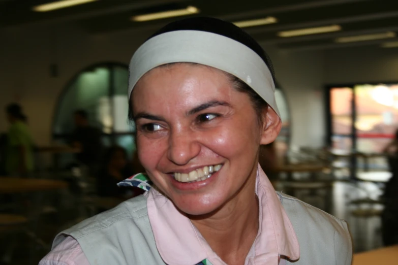 a woman with a head scarf is smiling