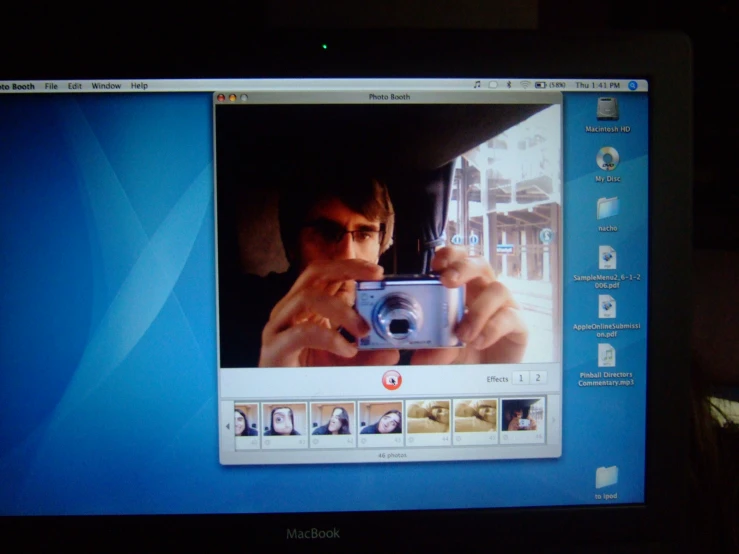 a monitor showing a picture with a man looking through the camera