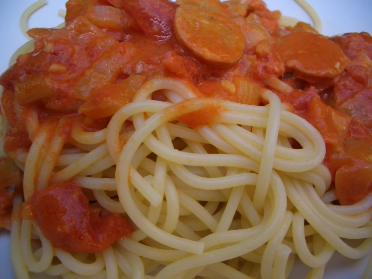 noodles and vegetable sauce on top of a white plate