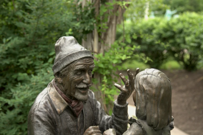 a statue of a old man holding a small girl