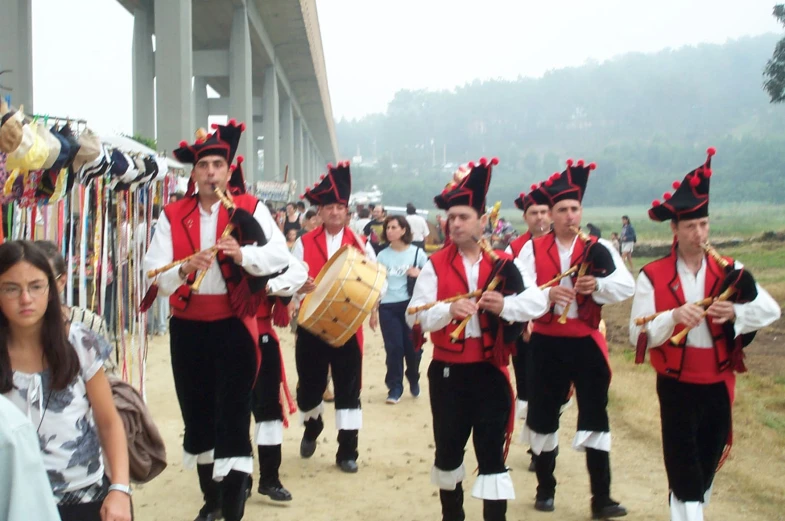 a group of people in costume marching with a bag