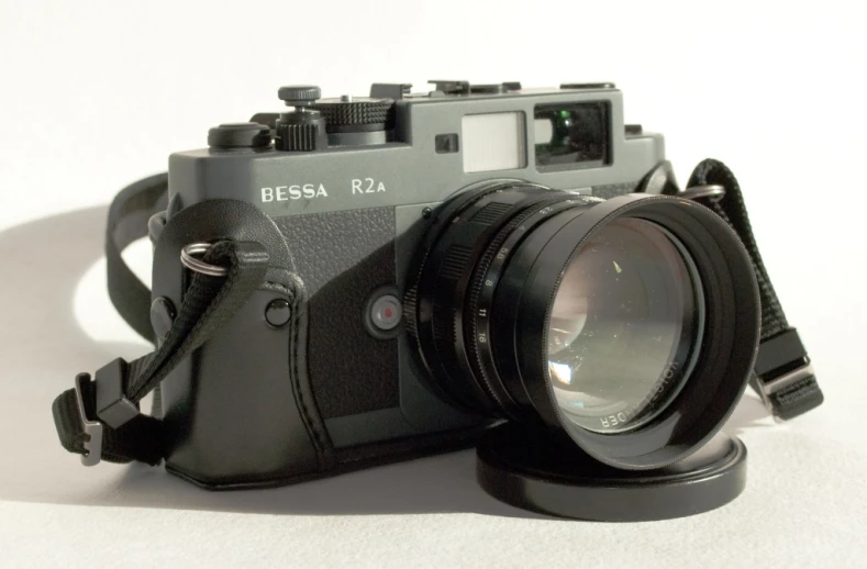 a camera with a black body and black strap