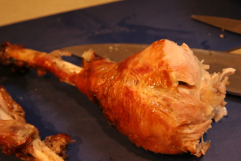 a roast chicken is being prepared with a knife