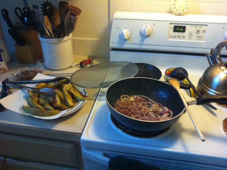 a cooking pot on the stove with food in it